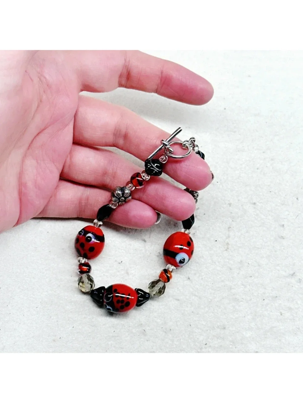 3011u. Silly Ladybug Glass Bracelet Silvertone